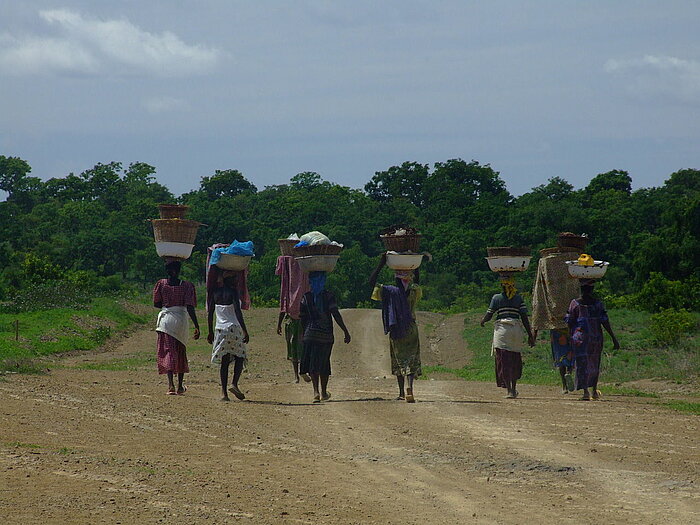 Frauen kehren in Ghana mit der Wäsche heim