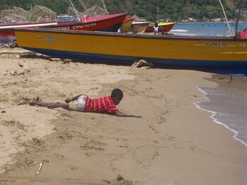 Kind am Strand von Jamaika